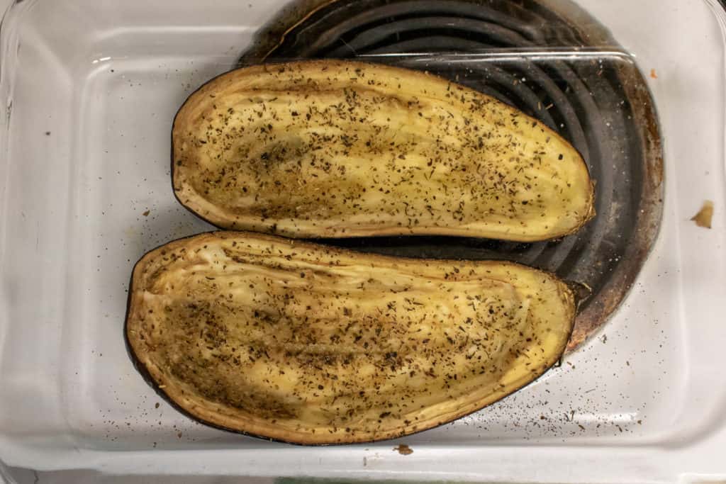 Two halves of eggplant after roasting to a golden color. 