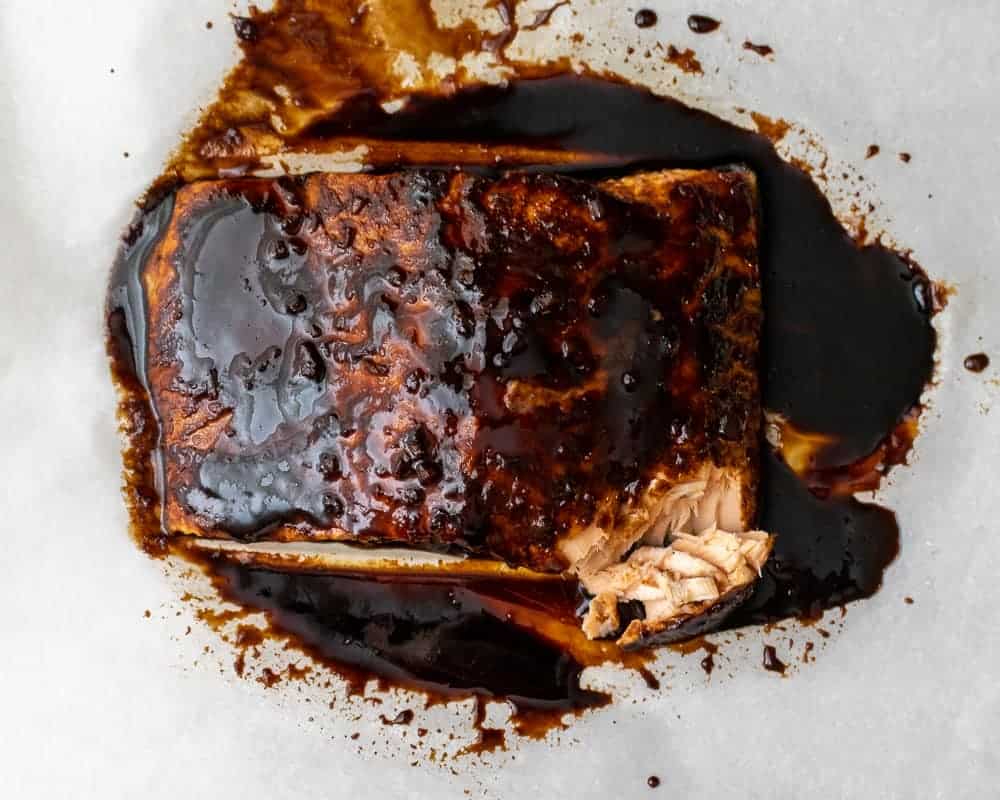 Balsamic salmon filet on parchment paper.