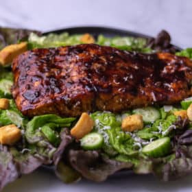 Balsamic glazed salmon on a bed of lettuce