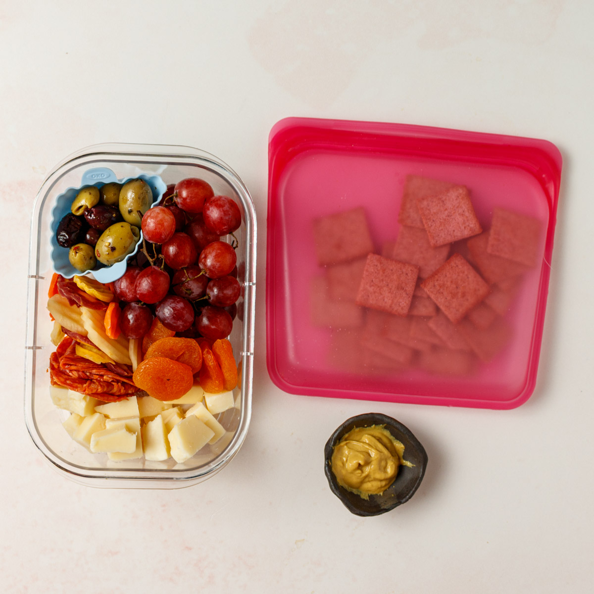 Mini Cheese plate in a take out container.