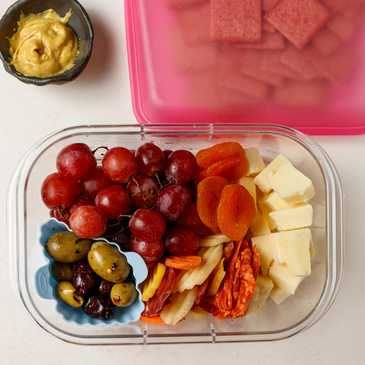 Mini Cheese plate in a take out container.