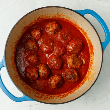 A dutch oven of meatballs in sauce