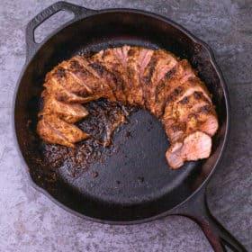 Cut cajun pork tenderloin in a cast iron skillet