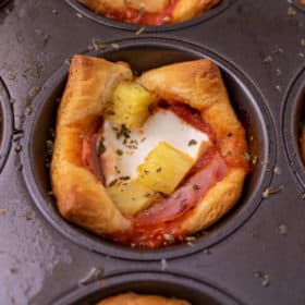 Close up of hawaiian pizza muffins in muffin twin