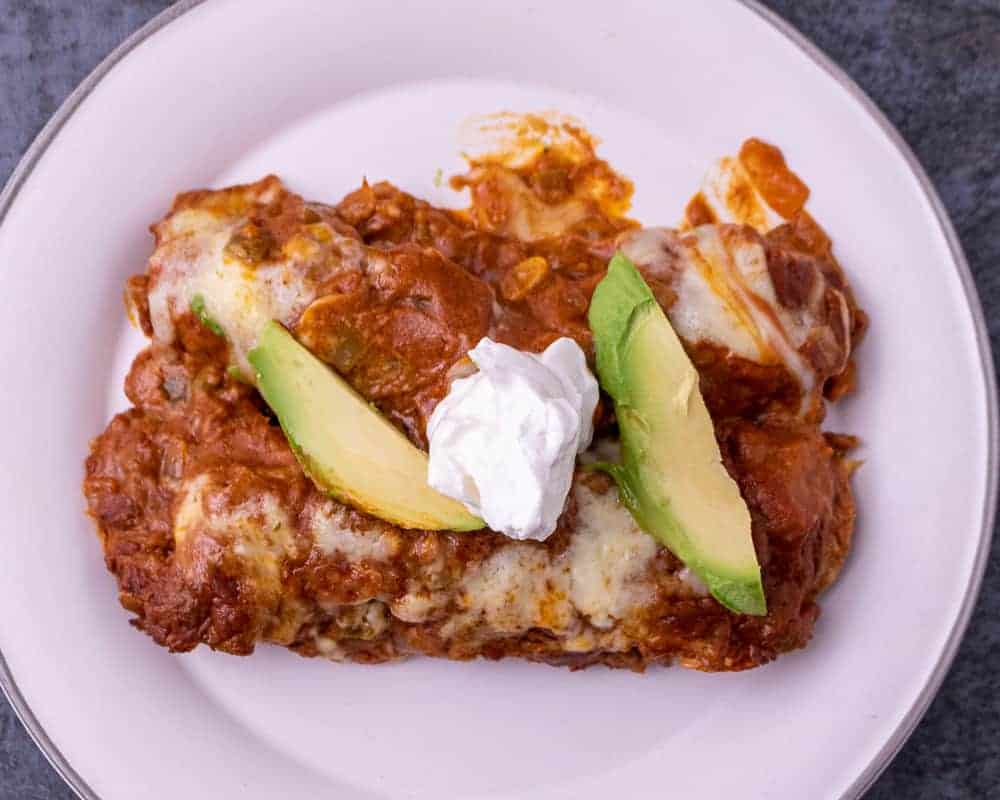 Close up of a plate of chicken enchiladas