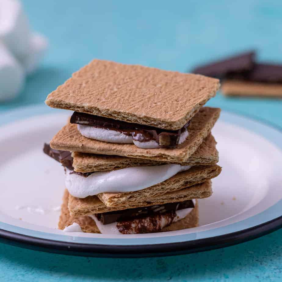 3 assembled stacked s'mores on a plate.