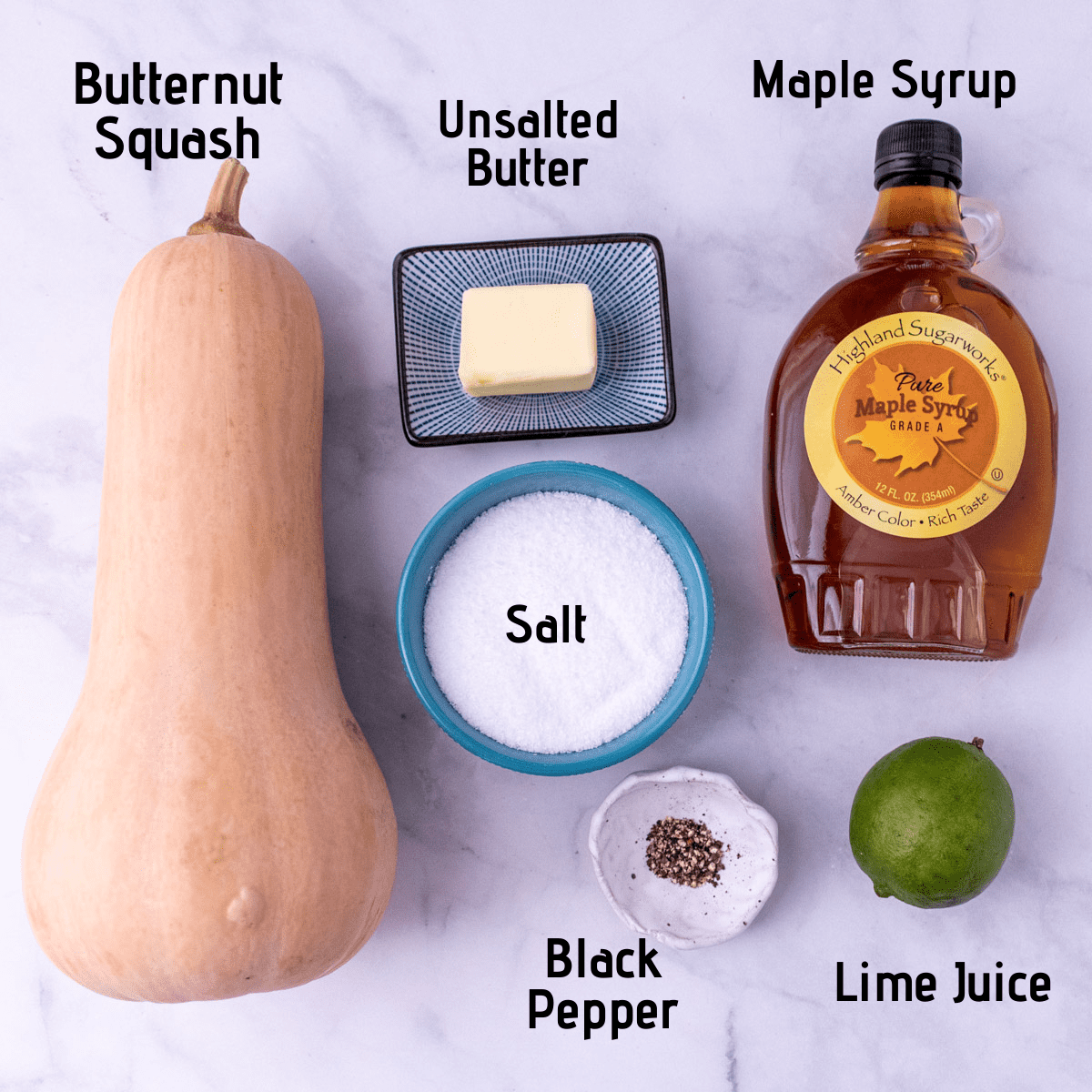 Ingredients for butternut squash laid out on a white background with labels, butternut squash, unsalted butter, maple syrup, salt, black pepper, lime juice.