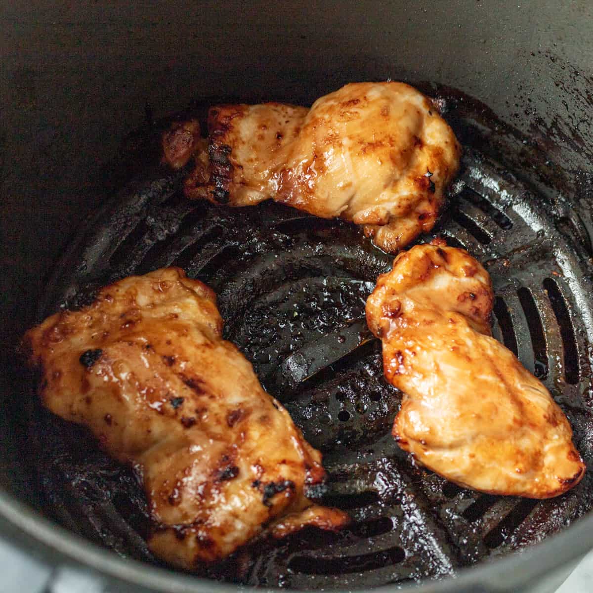 Three chicken thighs cooked in the air fryer. 