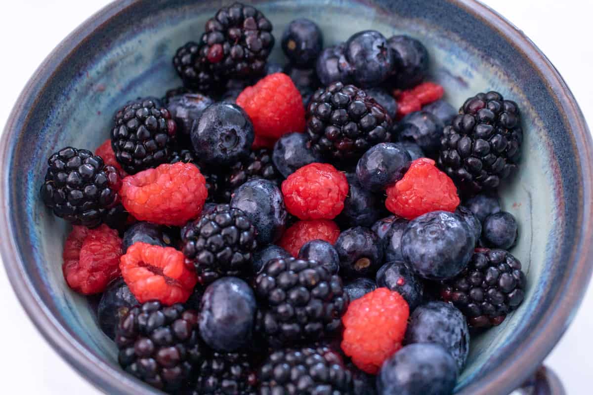 Close up of fresh blackberries, blueberries and raspberries in a bowl