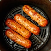 Cooked chicken sausage in the air fryer basket