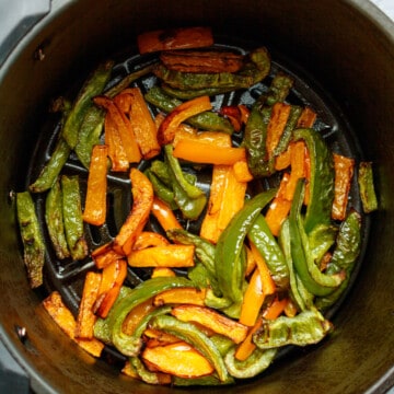 Green and orange sliced bell peppers cooked in the air fryer.